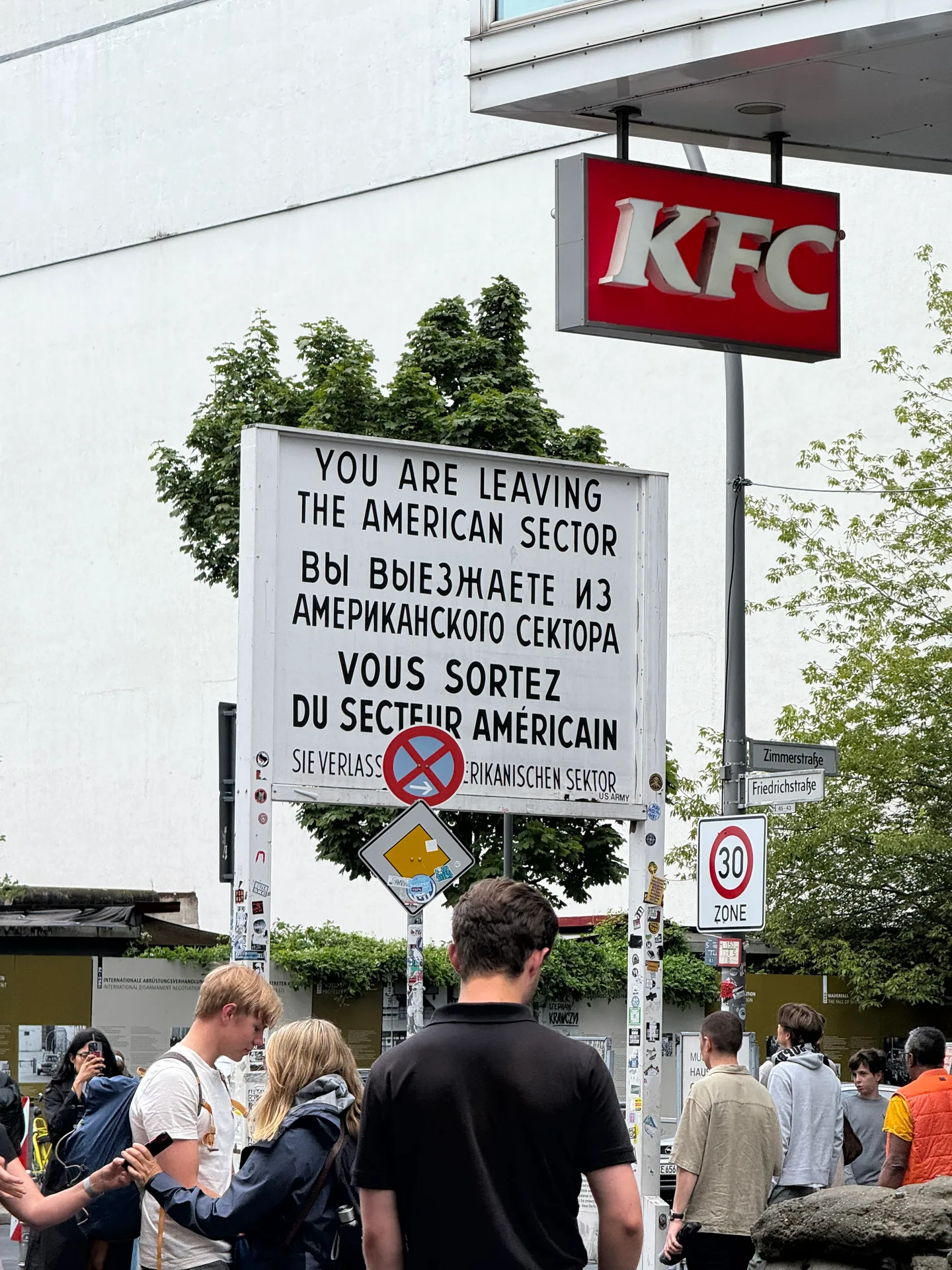 The multilingual sector sign beside modern shops